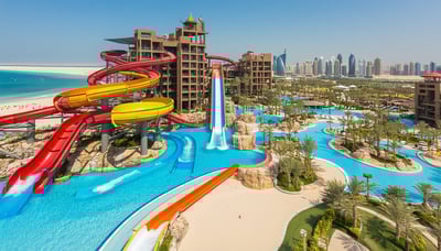 Aerial view of Aquaventure World Dubai with water slides, pools, and beach. Aerial view of Aquaventure World Dubai with water slides, pools, and beach.